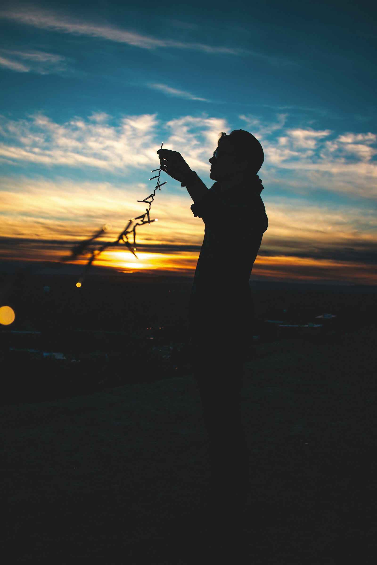 Canon EOS 70D + Canon EF-S 18-55mm F3.5-5.6 IS II sample photo. Silhouette of person holding photography