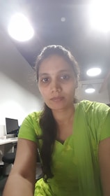 A student receiving guidance from a mentor in a bright, green-yellow themed office.