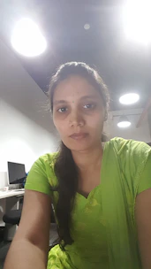 An Indian government officer with a locomotor disability confidently working at a desk in a bright, modern office.