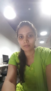 Portrait of Dilshad, the founder, in a sleek office with neon green accents and data screens.