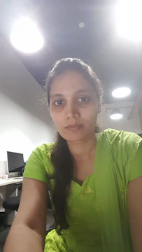 An Indian professional analyzing financial documents in a bright office.
