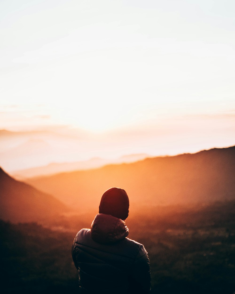 silhouette of man looking at sunset