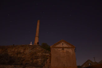 Nighttime scene of a repair technician fixing a chimney on a Fresno home.