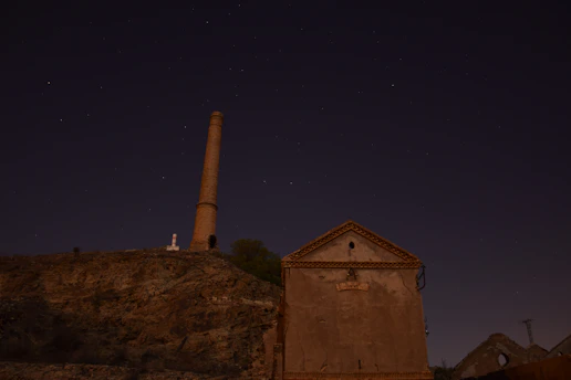 Nighttime scene of a repair technician fixing a chimney on a Fresno home.