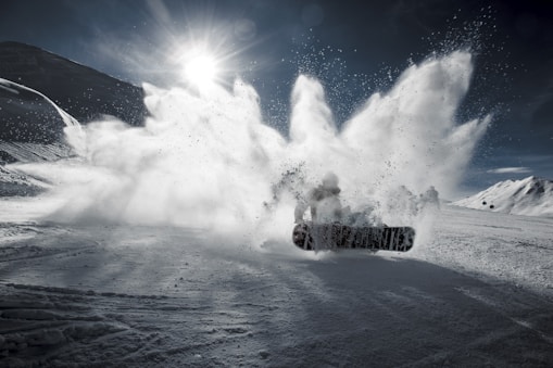 person snowboarding on mountain during daytime