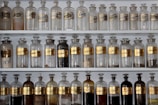 Bottles of medical-grade alcohol neatly arranged on a factory shelf.