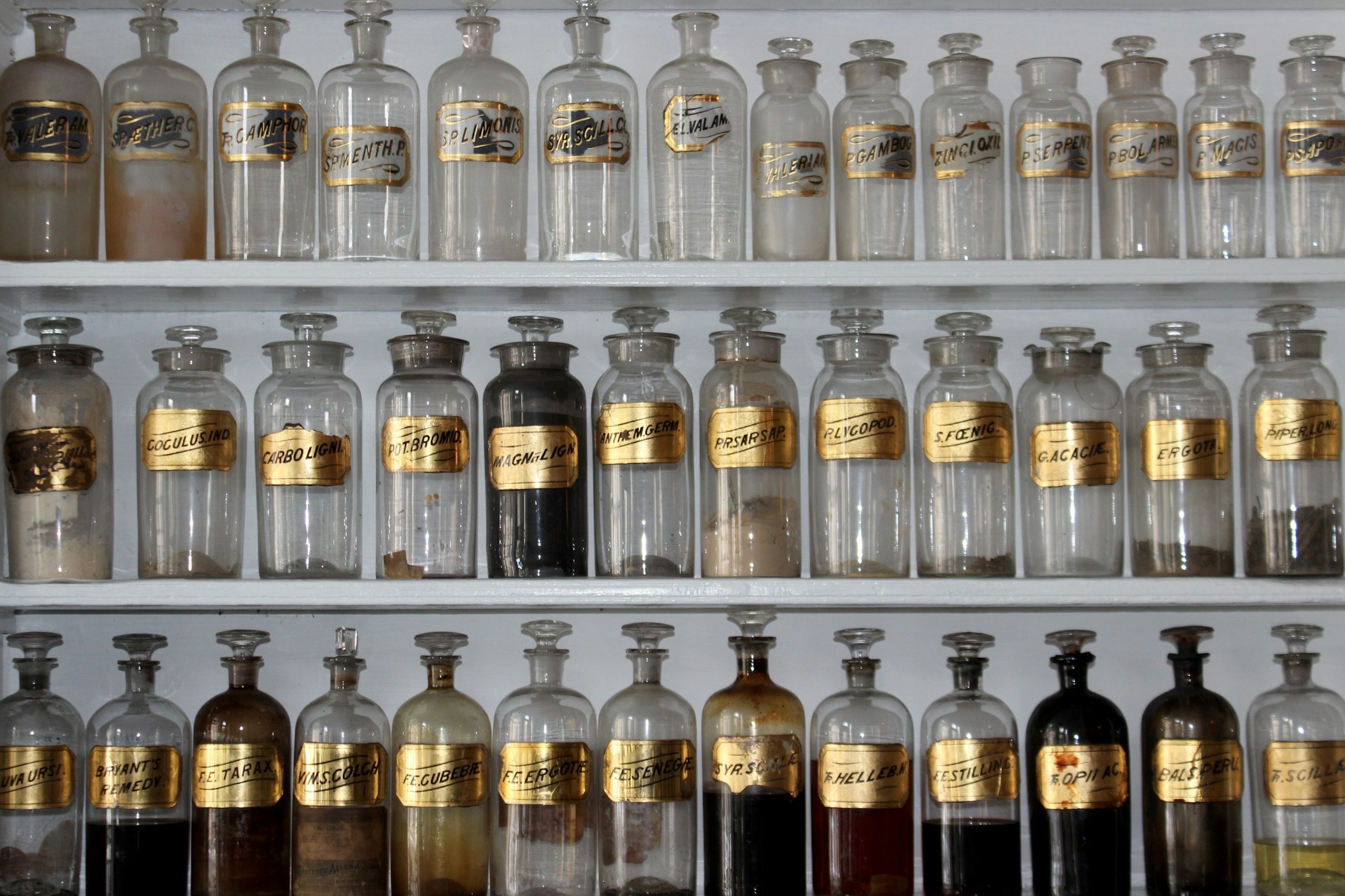 three levels of jars lined up with gold labels