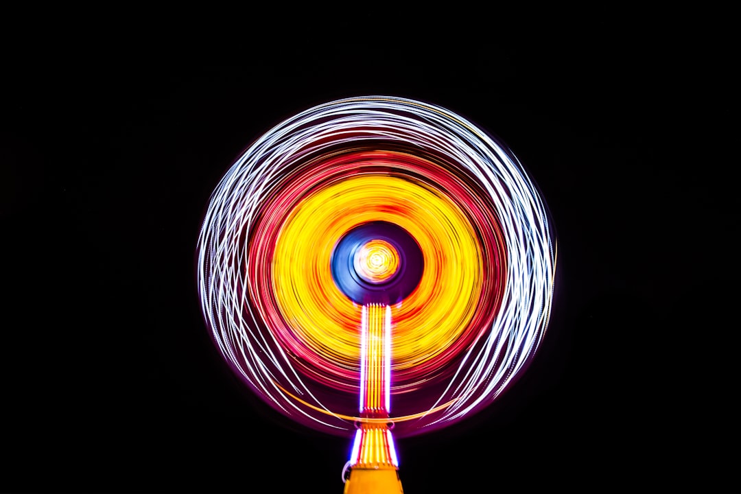 yellow lighted spin toy, Illuminated Cocoa Beach carnival ride