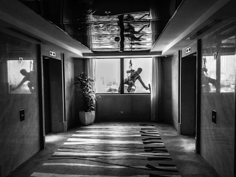 Realistic image of a professional cleaner carefully cleaning a residential building lobby.