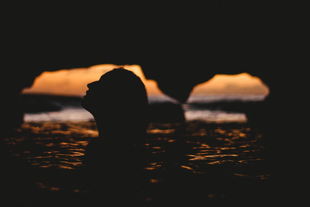 silhouette of woman inside cave