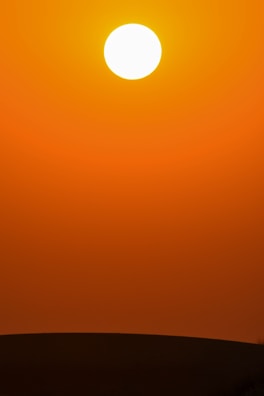 A radiant sun symbol glowing over a calm horizon, representing the vibrant energy of natural leadership.