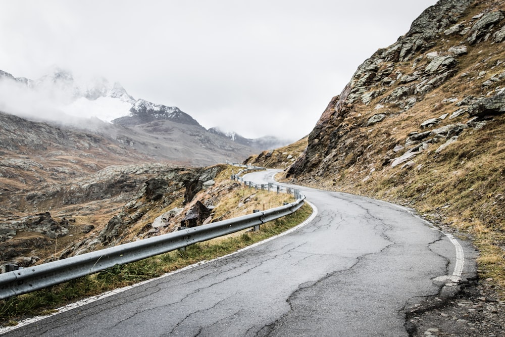 gray concrete road near mountain