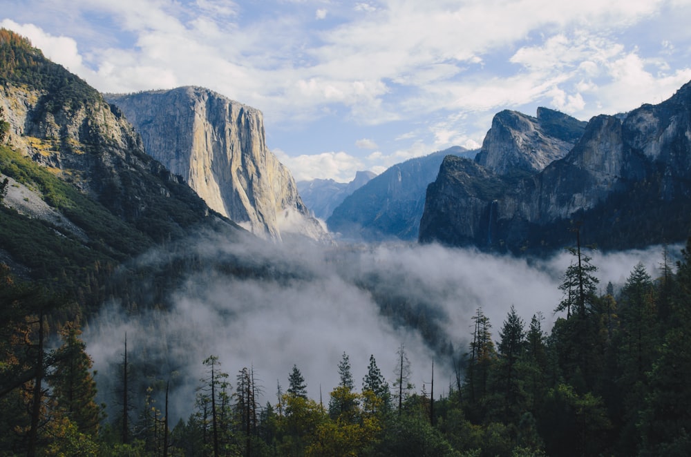 smoke at the foot of mountain during daytime