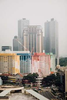 multicolored concrete high rise building near water