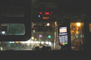 Close-up of a taxi meter and steering wheel inside a vehicle.