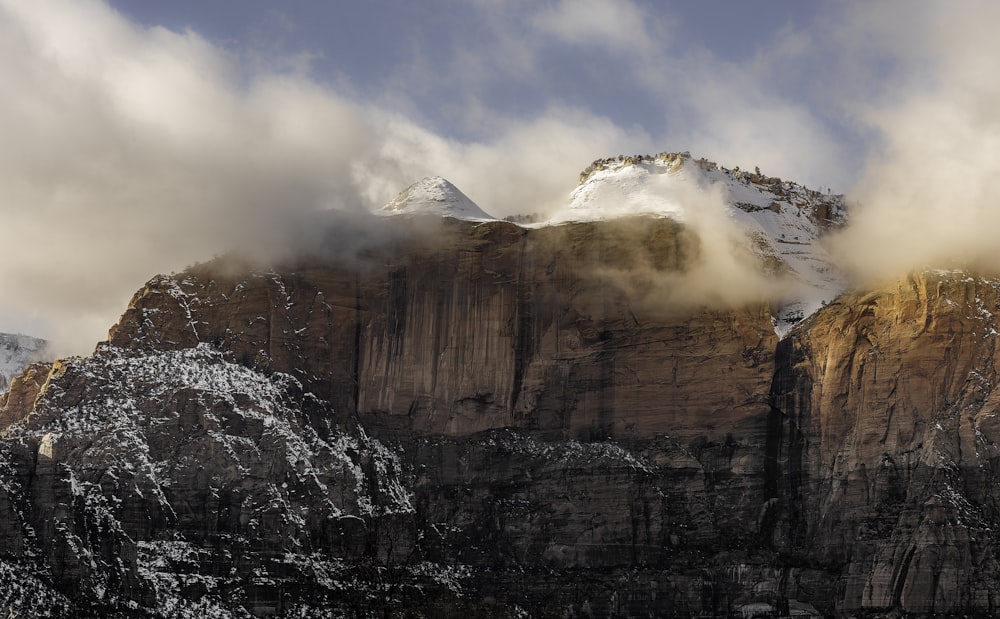 white covered rock mountains under white sky