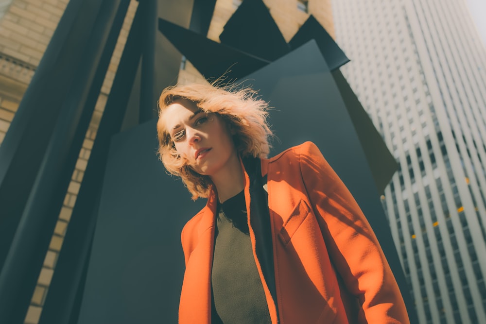 woman in orange suit jacket