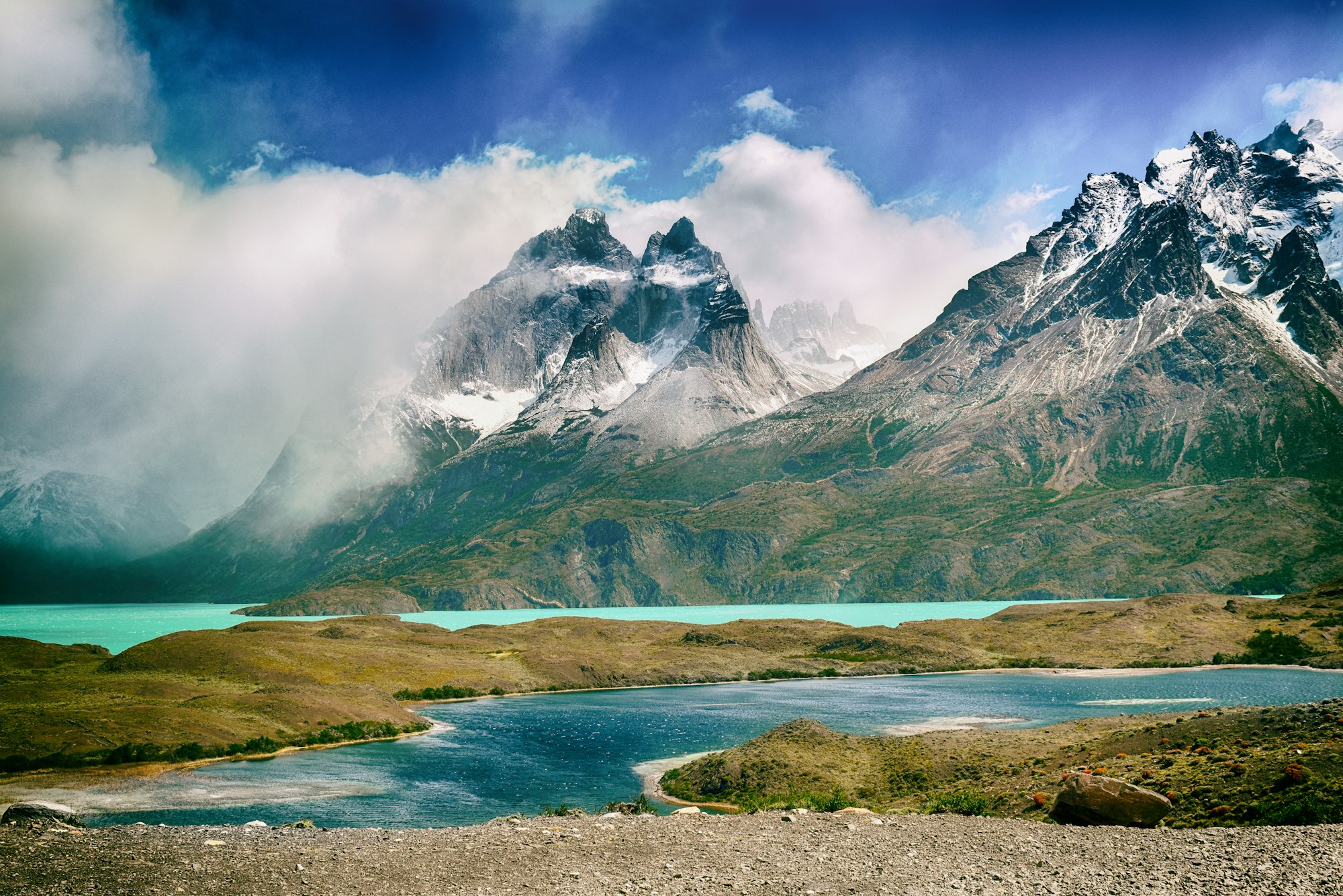 snow-covered mountain peaks beyond lakes (in Torres del Paine National Park, Chile)