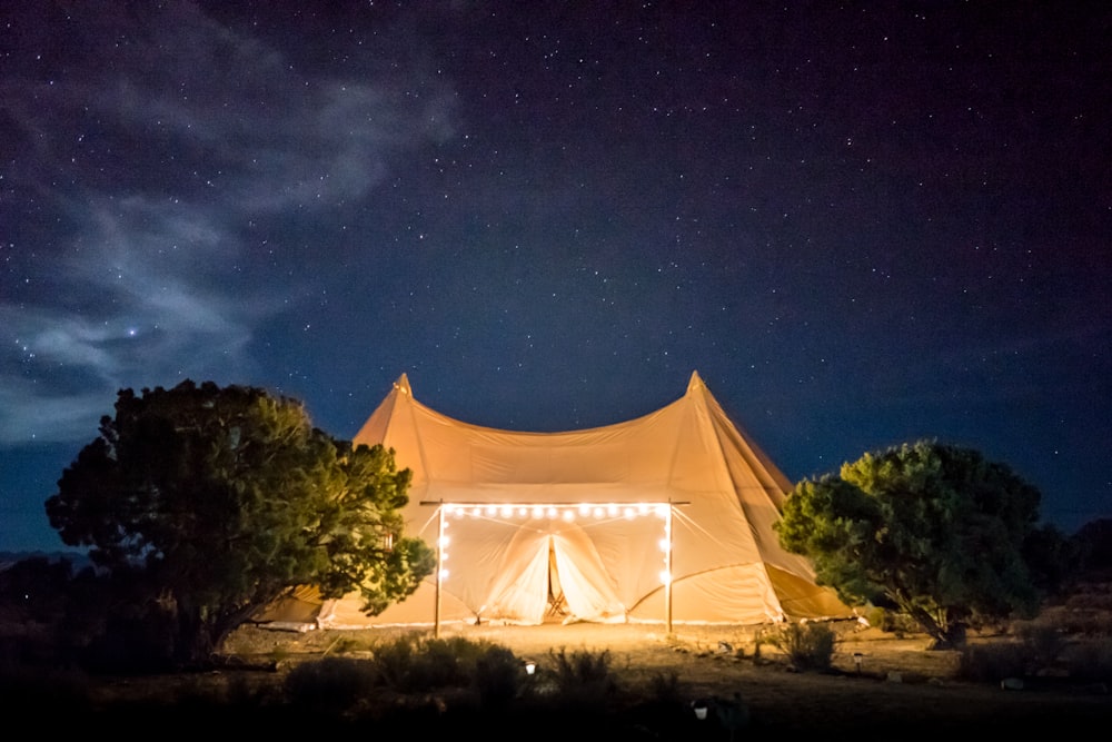 beige tent under starry skies
