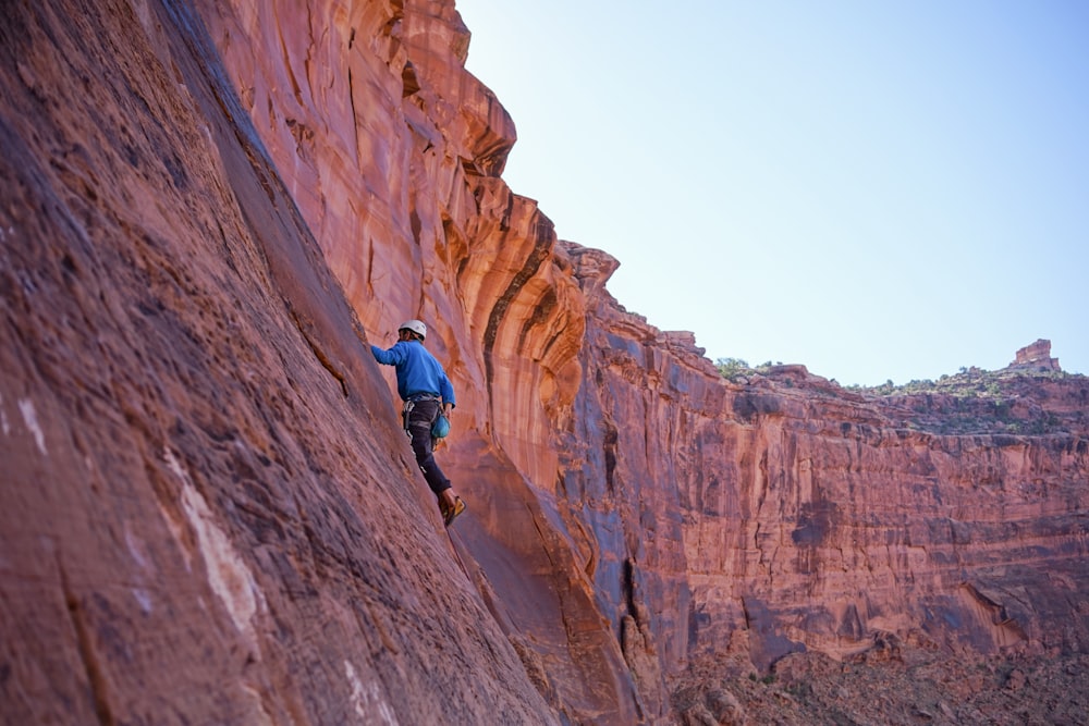 man climbing on mountain rock