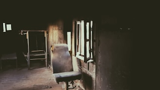Dimly lit corner featuring a worn-out chair and a forgotten cup of cold coffee.