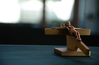 brown wooden crucifixion on blue surface