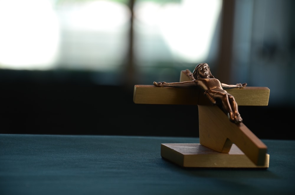 brown wooden crucifixion on blue surface