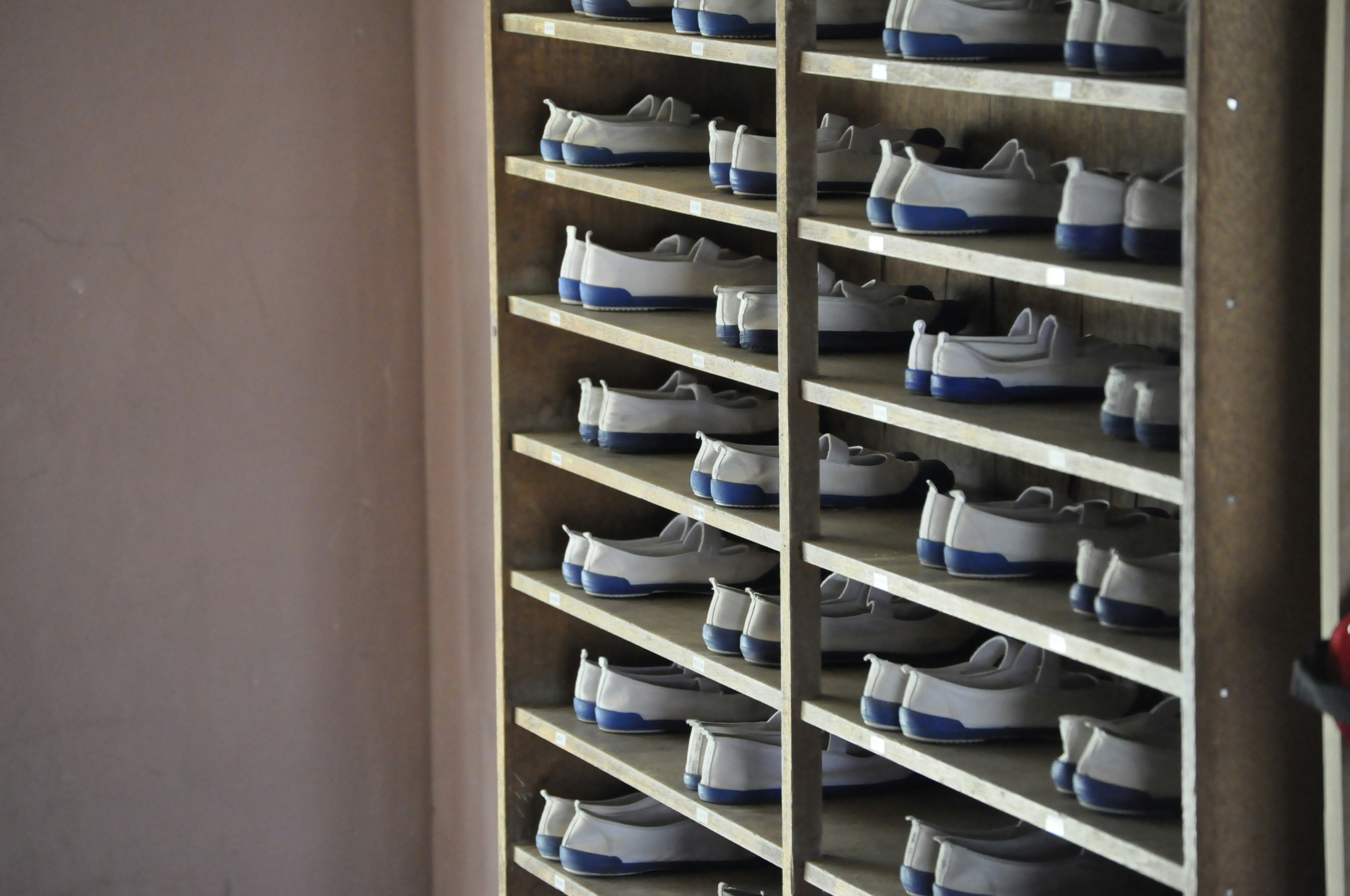 white and blue shoes in rack inside room