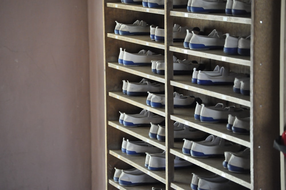 white and blue shoes in rack inside room