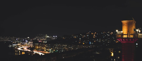 Nighttime cityscape of Marseille with glowing streetlights.