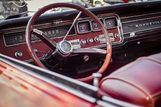 selective photography of red steering wheel