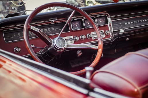 selective photography of red steering wheel