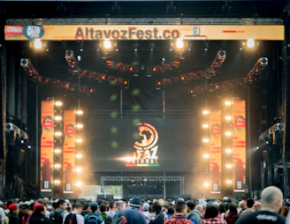 Massive LED screen displaying live footage at a crowded outdoor festival.