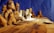 A detailed wooden sculpture featuring multiple figures seated around a long table, resembling a famous biblical scene. The intricate carvings capture expressions and details of each figure, and the craftsmanship highlights the wood grain and carving techniques.