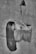 An artistic image of an old, used paintbrush seemingly brushing across an old paper or wall surface. Interestingly, part of a woman's face with long hair is seamlessly integrated with the brush stroke, creating a surreal visual effect. The image is in black and white, adding a nostalgic and mysterious atmosphere.