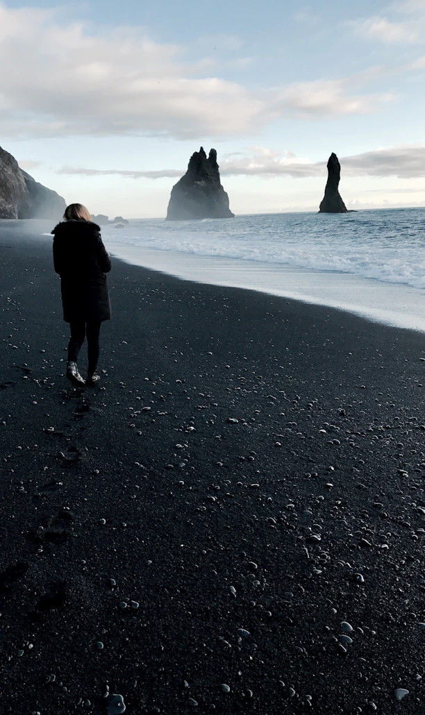 person walking near body of water