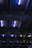 Close-up of a sleek LED high bay light casting bright, uniform beams in a modern industrial warehouse.