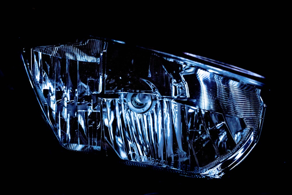 a close up of a car headlight in the dark
