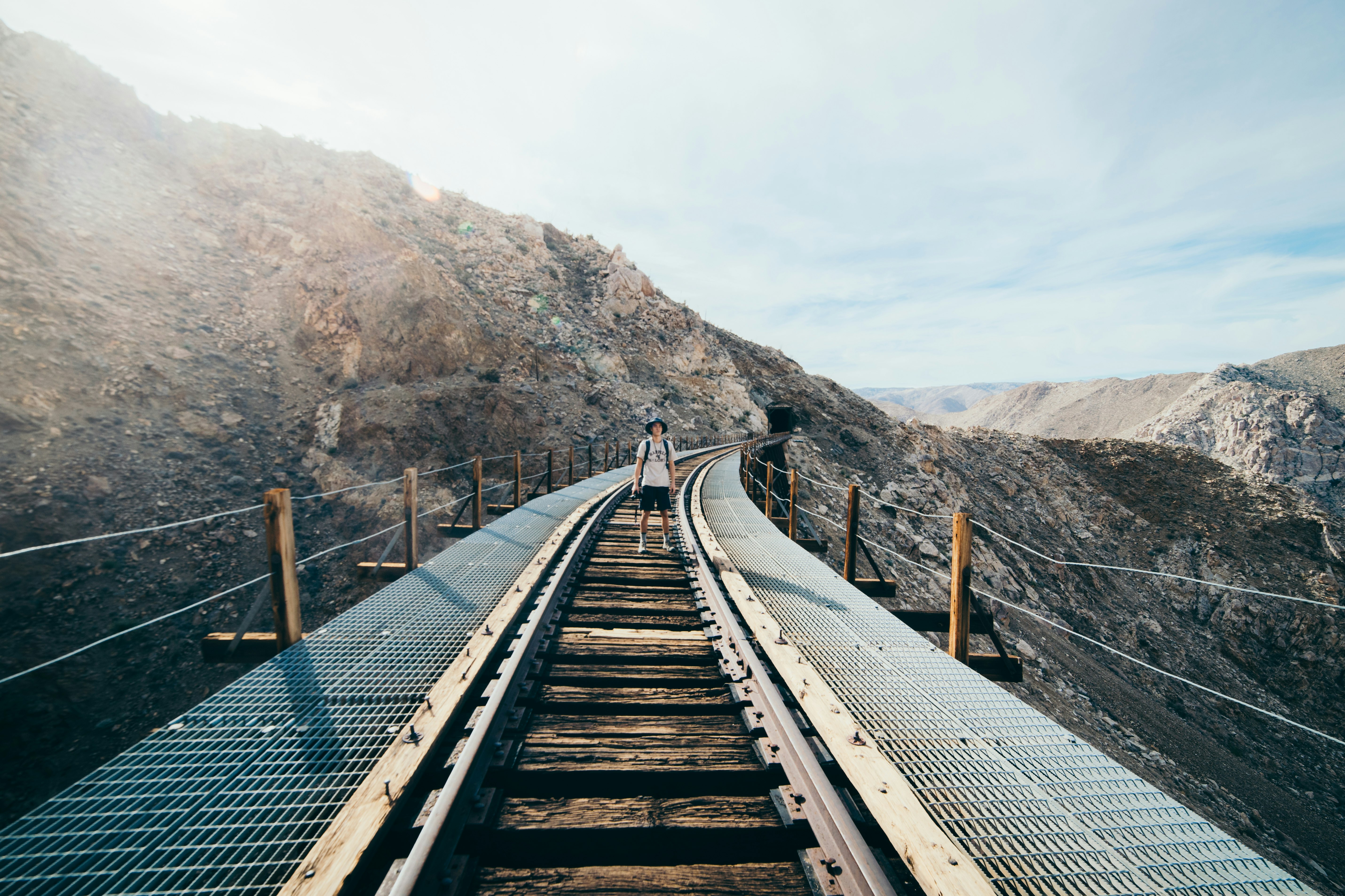 person standing on train road rail