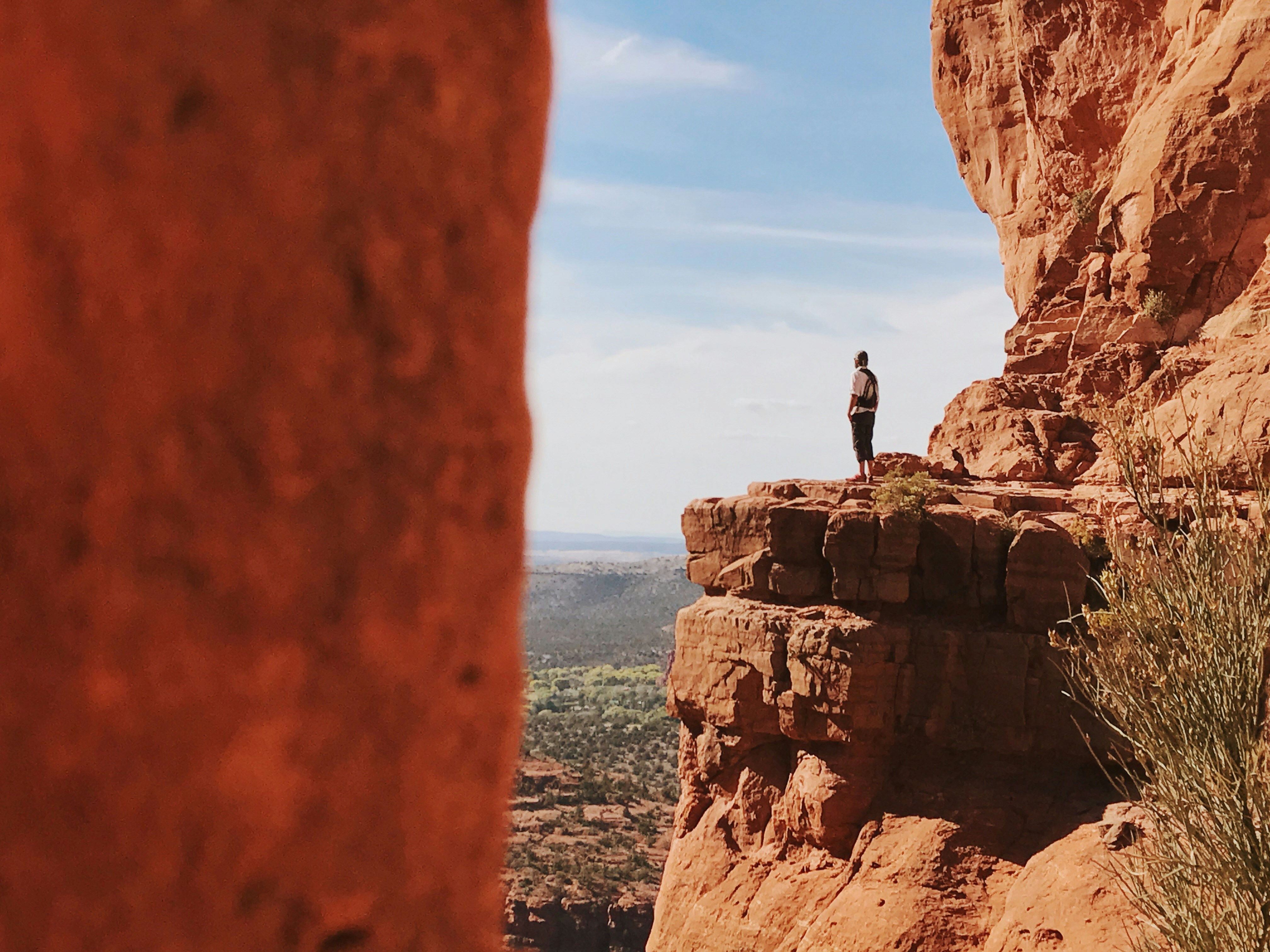 One person standing close to the edge of a cliff alone in Sedona