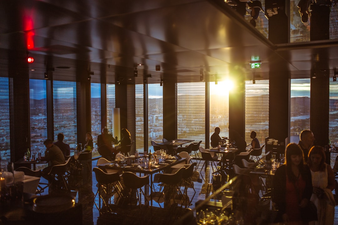 people gathering inside cafe during golden hour, Restaurant at dusk