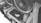 Close-up view of a computer's internal components featuring liquid cooling tubes and cooling fans. The ASUS Republic of Gamers (ROG) logo is visible on a hardware component, likely the graphics card. The image is in grayscale, highlighting the intricate design and layout of the PC internals.