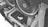 Close-up view of a computer's internal components featuring liquid cooling tubes and cooling fans. The ASUS Republic of Gamers (ROG) logo is visible on a hardware component, likely the graphics card. The image is in grayscale, highlighting the intricate design and layout of the PC internals.