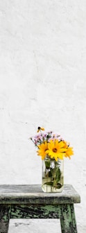 sunflower with clear glass vase on gray table