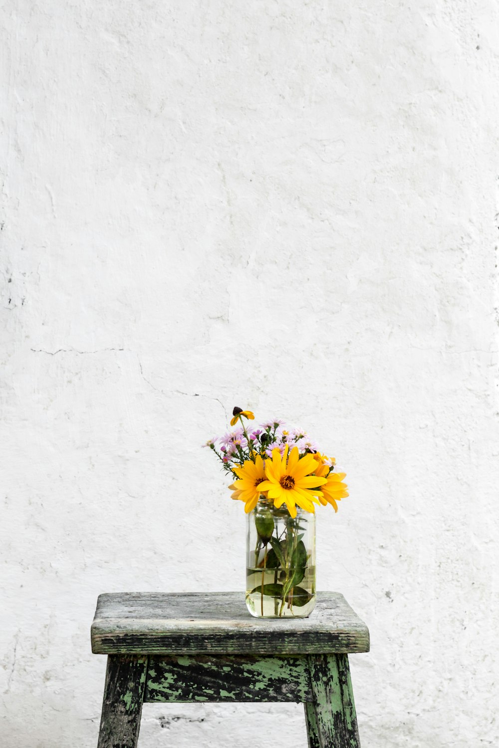 sunflower with clear glass vase on gray table