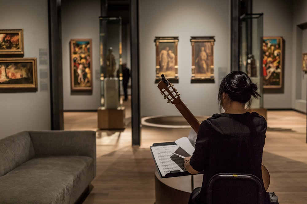 woman playing classical guitar