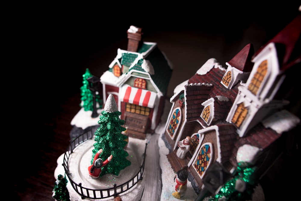 A model of the Christmas holiday replete with church, Christmas tree, snowman, house and people