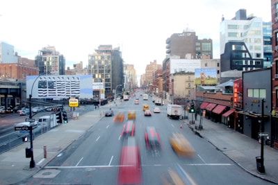 A busy urban scene with delivery vehicles and pedestrians.