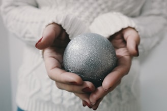 woman holding gray bath bomb