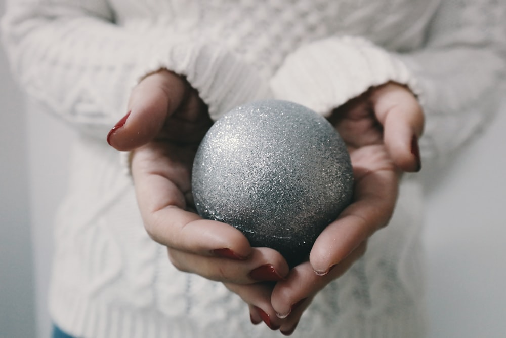 woman holding gray bath bomb